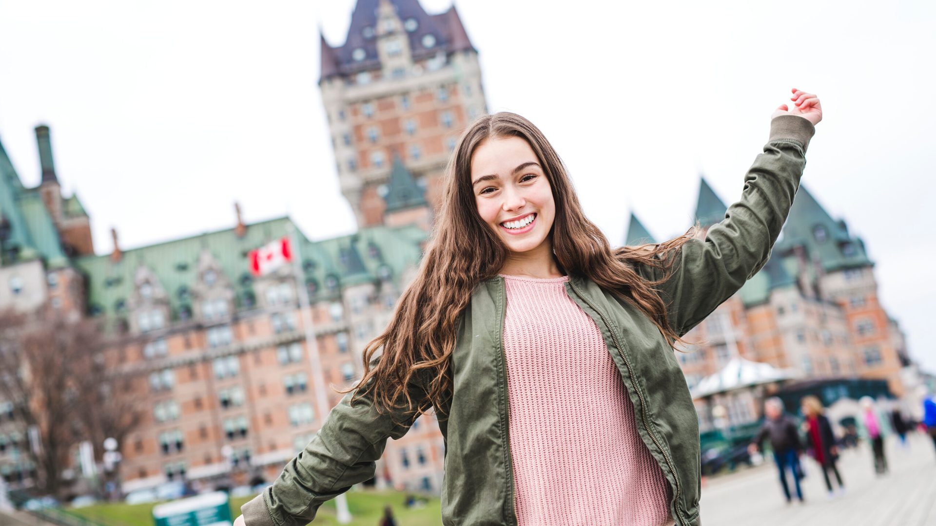 A Quebec City scape with Chateau Frontenac and young teen enjoying the view.