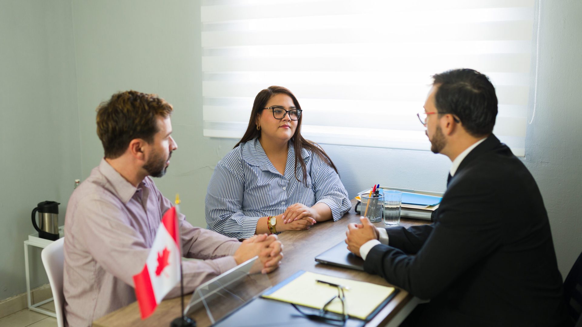 Couple having a legal consultation with an immigration lawyer, discussing their options for moving to canada