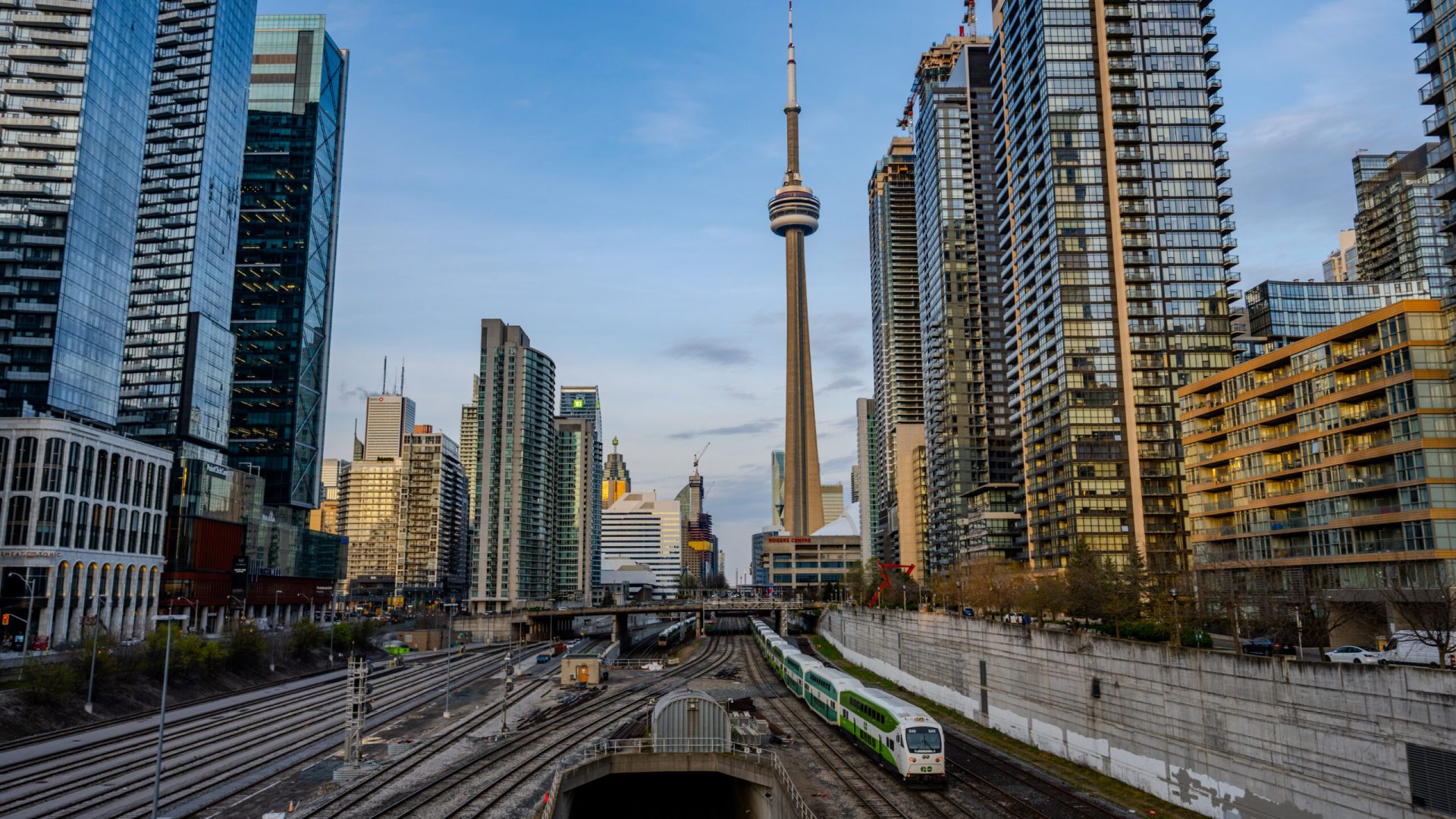 Commuter train tracks leading into downtown Toronto skyline