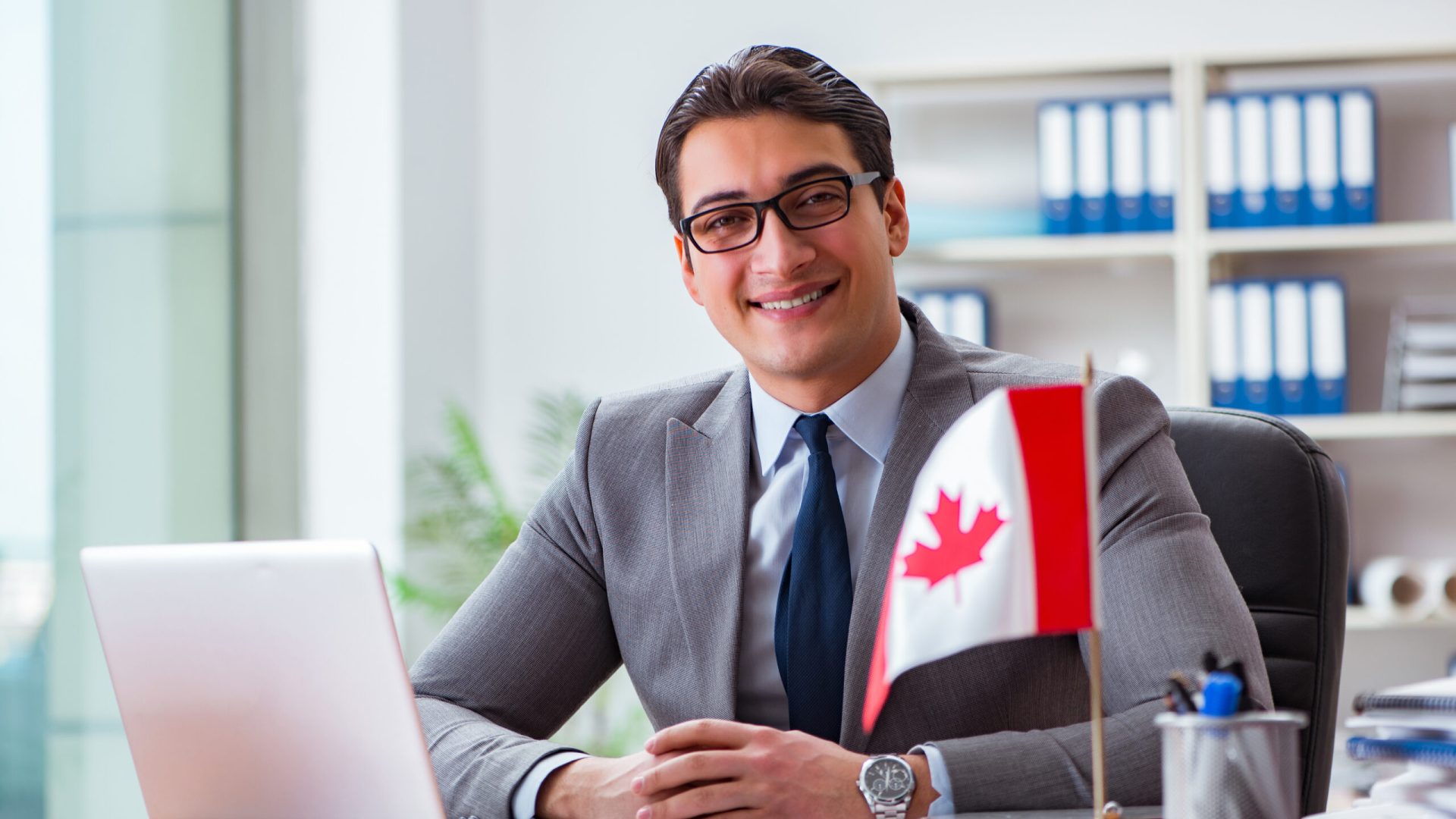 Businessman with Canadian flag in office