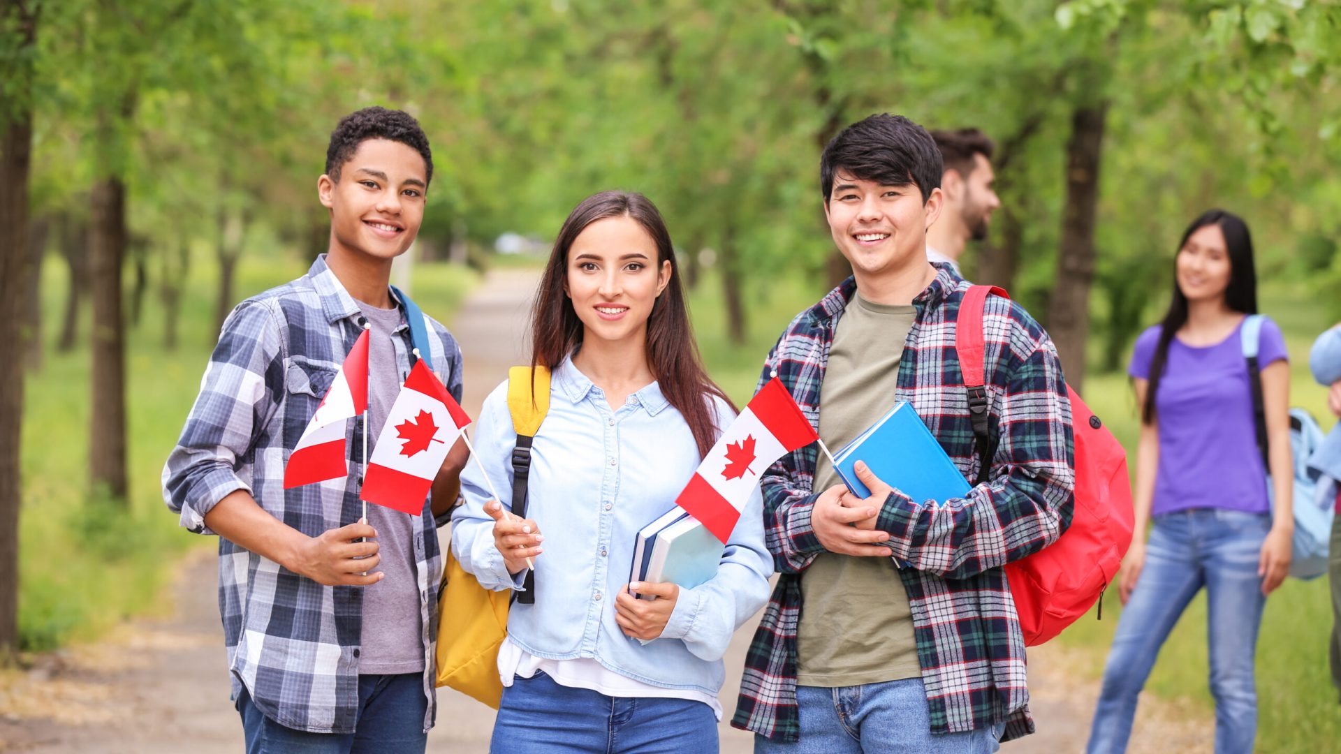 Group of students with Canadian flags outdoors